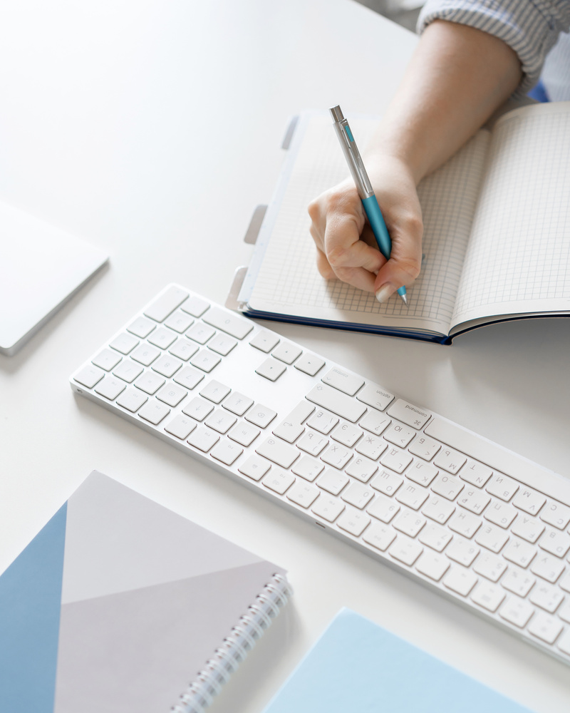 Close-up of Person Writing in a Notebook 